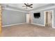 An empty room features neutral carpet, tray ceiling, and a ceiling fan at 101 Lager Ln, Garner, NC 27529