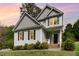 Charming two-story home with gray siding, black shutters, and a well-manicured lawn at 101 Lager Ln, Garner, NC 27529