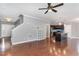 Open-concept living area with hardwood floors connecting the living room and kitchen at 101 Lager Ln, Garner, NC 27529