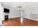 Bright living room with hardwood floors, a fireplace, and a view of the staircase at 101 Lager Ln, Garner, NC 27529