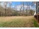 Spacious backyard with mature trees, open lawn, and the rear of the house visible on the right at 101 Redfoot Run Rd, Chapel Hill, NC 27516