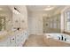 Well lit bathroom boasts dual sinks, a soaking tub, and a separate glass shower with tiled floors at 101 Redfoot Run Rd, Chapel Hill, NC 27516