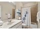 Bright bathroom with a single sink vanity, tiled shower and tub combo, and neutral decor at 101 Redfoot Run Rd, Chapel Hill, NC 27516