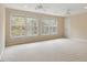 Well-lit bedroom featuring neutral carpet, twin ceiling fans, and large windows with serene views at 101 Redfoot Run Rd, Chapel Hill, NC 27516