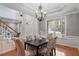 Formal dining room boasts elegant chandelier, chair railing, and large windows with natural light at 101 Redfoot Run Rd, Chapel Hill, NC 27516