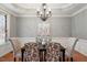Formal dining room with a chandelier and wainscoting, bathed in natural light at 101 Redfoot Run Rd, Chapel Hill, NC 27516