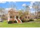 Charming brick home featuring a well-manicured lawn and inviting entrance stairs at 101 Redfoot Run Rd, Chapel Hill, NC 27516