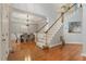 Foyer with staircase and dining room, showcasing hardwood floors and neutral color palette at 101 Redfoot Run Rd, Chapel Hill, NC 27516