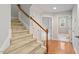 Inviting hallway with hardwood floors, carpeted stairs, and a blend of natural and recessed lighting at 101 Redfoot Run Rd, Chapel Hill, NC 27516