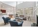 Open-concept living area featuring hardwood floors, a fireplace, and large windows with backyard views at 101 Redfoot Run Rd, Chapel Hill, NC 27516