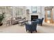Elegant living room showcasing a fireplace, built-in shelving, and large windows at 101 Redfoot Run Rd, Chapel Hill, NC 27516