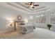 Serene main bedroom with a tray ceiling, bay windows, and comfortable furnishings at 101 Redfoot Run Rd, Chapel Hill, NC 27516