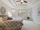 Cozy main bedroom featuring a tray ceiling, large windows, and plush carpeting at 101 Redfoot Run Rd, Chapel Hill, NC 27516