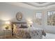Comfortable main bedroom showcasing a tray ceiling, soft lighting, and bay windows at 101 Redfoot Run Rd, Chapel Hill, NC 27516