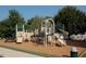 Community playground offers multiple slides and climbing structures in a wood chip safety environment at 101 Redfoot Run Rd, Chapel Hill, NC 27516