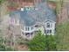 Expansive home with unique architectural design and mature landscaping, complemented by a charming covered porch at 104 Sierra Dr, Chapel Hill, NC 27514