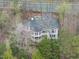 Stunning aerial shot of a beautifully landscaped home surrounded by trees and a private yard at 104 Sierra Dr, Chapel Hill, NC 27514