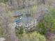 Expansive aerial view showcasing the beautiful home surrounded by mature trees and lush landscaping at 104 Sierra Dr, Chapel Hill, NC 27514