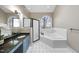 Bright bathroom featuring a soaking tub, black fixtures and a glass enclosed shower at 104 Sierra Dr, Chapel Hill, NC 27514