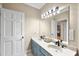Bright bathroom featuring a double vanity, large mirror, and modern lighting fixtures at 104 Sierra Dr, Chapel Hill, NC 27514