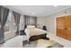 Comfortable bedroom with natural light from large windows and a neutral color scheme creates a cozy and inviting atmosphere at 104 Sierra Dr, Chapel Hill, NC 27514