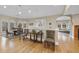 Bright dining room featuring hardwood floors, a rustic table, and large windows at 104 Sierra Dr, Chapel Hill, NC 27514