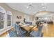 This airy dining room features hardwood floors, a ceiling fan, and large windows at 104 Sierra Dr, Chapel Hill, NC 27514