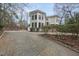 Elegant two-story residence with a turret design, beautiful shrubbery, and a convenient basketball court at 104 Sierra Dr, Chapel Hill, NC 27514