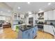 This updated kitchen features white cabinets, an island, and stainless steel appliances at 104 Sierra Dr, Chapel Hill, NC 27514