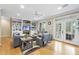 Open-concept living room with hardwood floors, built-in shelving, fireplace, and access to patio at 104 Sierra Dr, Chapel Hill, NC 27514