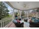 Inviting porch area with stone accents, comfortable seating, and views of the surrounding greenery, perfect for relaxing outdoors at 104 Sierra Dr, Chapel Hill, NC 27514