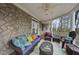 Inviting porch area with stone accents, comfortable seating, and views of the surrounding greenery, perfect for relaxing outdoors at 104 Sierra Dr, Chapel Hill, NC 27514