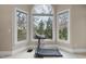 Window view featuring a picturesque view of the surrounding tree line and a treadmill at 104 Sierra Dr, Chapel Hill, NC 27514