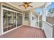 View of the balcony with a ceiling fan and sliding glass doors with a view of trees in the distance at 10411 Rosegate Ct # 304, Raleigh, NC 27617