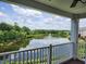 Scenic balcony view of a serene lake with a fountain, surrounded by lush greenery and a clear, blue sky at 10411 Rosegate Ct # 304, Raleigh, NC 27617