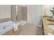 A bathroom with a glass enclosed shower, soaking tub, and granite countertop at 10411 Rosegate Ct # 304, Raleigh, NC 27617