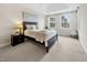A cozy bedroom features natural light from two windows and neutral tones throughout the space at 10411 Rosegate Ct # 304, Raleigh, NC 27617