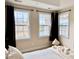 A well-lit bedroom featuring three windows offering views of the outdoors and access to natural light at 10411 Rosegate Ct # 304, Raleigh, NC 27617