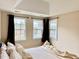 A well-lit bedroom featuring three windows offering views of the outdoors and access to natural light at 10411 Rosegate Ct # 304, Raleigh, NC 27617