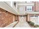 The exterior of a brick house with a driveway leading up to two garage doors at 10411 Rosegate Ct # 304, Raleigh, NC 27617