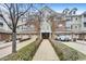Condominium building features a private garage, brick accents, and manicured landscaping at 10411 Rosegate Ct # 304, Raleigh, NC 27617