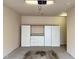 Inside the garage there is an installed storage system and concrete flooring at 10411 Rosegate Ct # 304, Raleigh, NC 27617