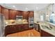 A modern kitchen featuring stainless steel appliances, custom cabinetry, and stone countertops at 10411 Rosegate Ct # 304, Raleigh, NC 27617