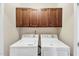 Bright laundry area with overhead cabinets and side by side washer and dryer at 10411 Rosegate Ct # 304, Raleigh, NC 27617