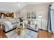 Inviting living room with neutral decor, plush seating, and access to adjacent open kitchen at 10411 Rosegate Ct # 304, Raleigh, NC 27617