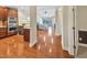 Open floorplan view from the kitchen area into the living room, featuring hardwood flooring and modern finishes at 10411 Rosegate Ct # 304, Raleigh, NC 27617