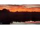 A breathtaking view of the sky reflecting off the pond at dusk with silhouetted trees in the distance at 10411 Rosegate Ct # 304, Raleigh, NC 27617