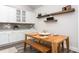 Kitchen dining area with a wooden table and floating shelves at 1053 Beechcraft Dr # 124, Mebane, NC 27302