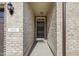 Entryway to a well maintained home with brick surround and accent lighting at 1053 Beechcraft Dr # 124, Mebane, NC 27302