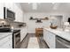 Modern kitchen with white cabinets, stainless steel appliances and a eat-in dining area at 1053 Beechcraft Dr # 124, Mebane, NC 27302